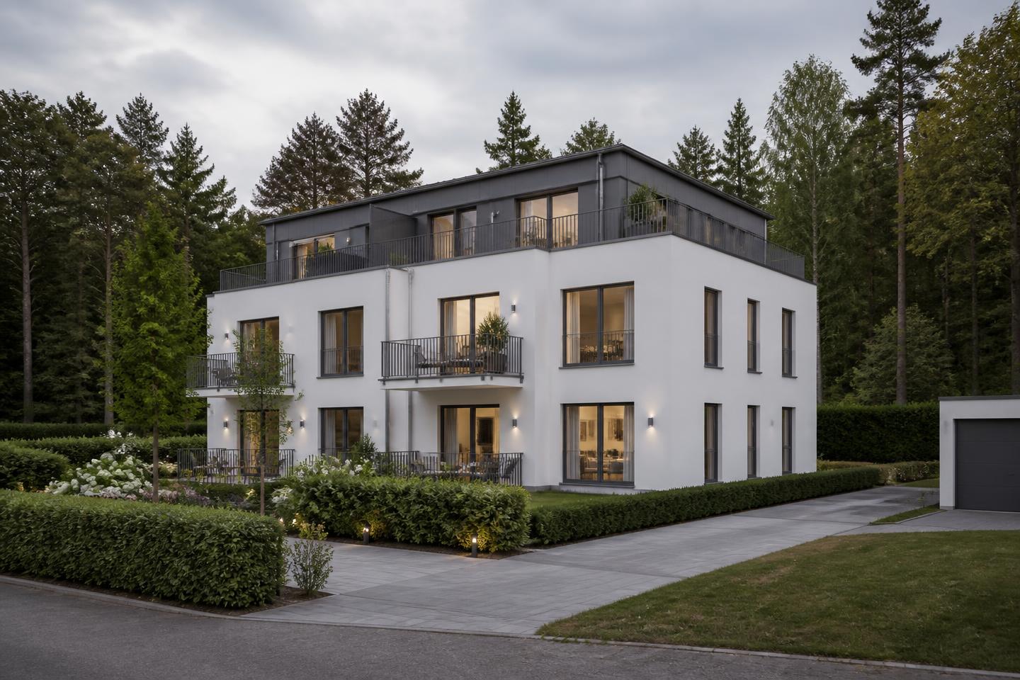 Visualisierung einer dreigeschossigen weißen Stadtvilla mit zurückgesetztem dunklem Staffelgeschoss, Balkonen und Terrassen am Waldrand